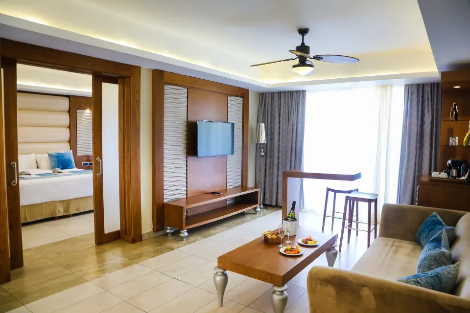 Living room and bedroom doorway in a Mirage Club suite at Majestic Mirage Punta Cana.