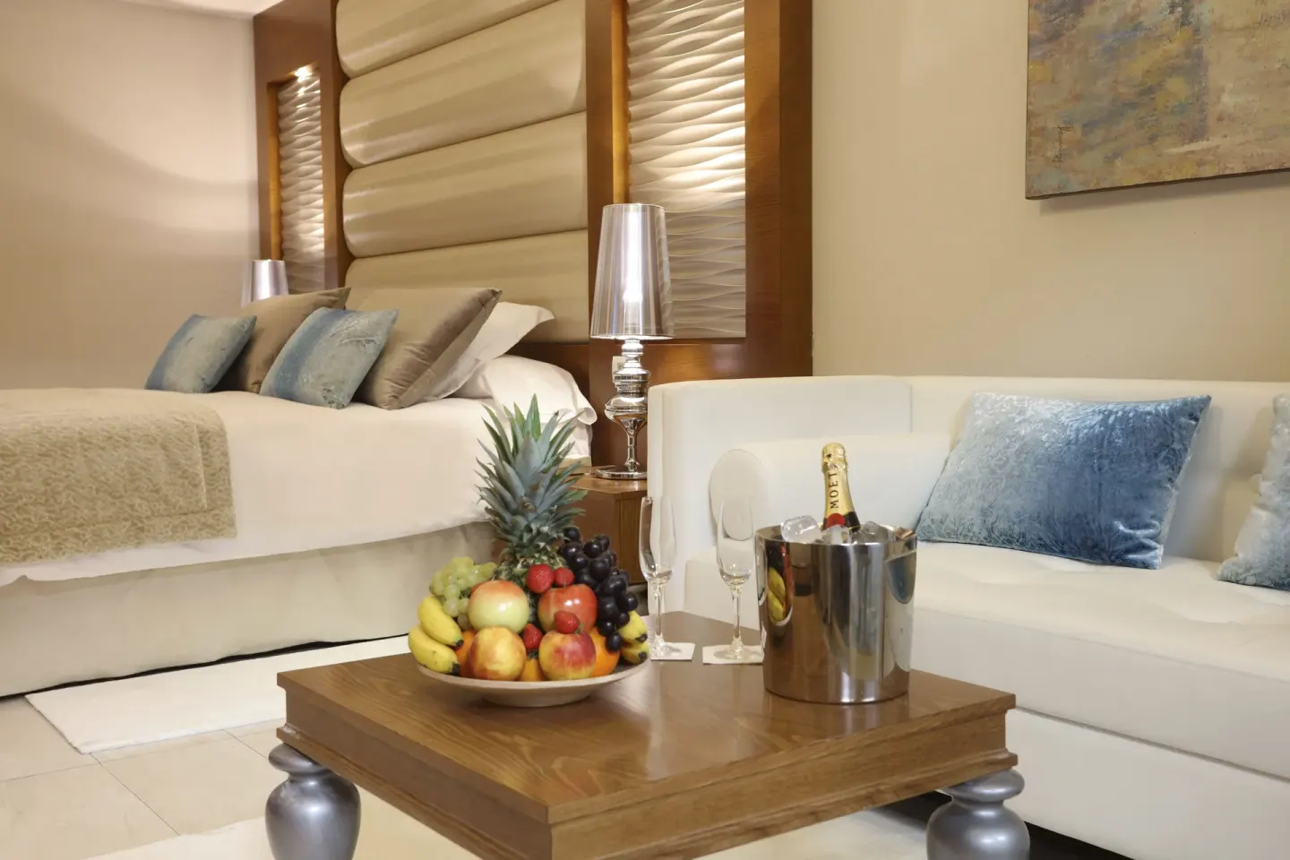Mirage Club Sky View Suite bed and sitting area with fruit and sparkling wine at Majestic Mirage Punta Cana.