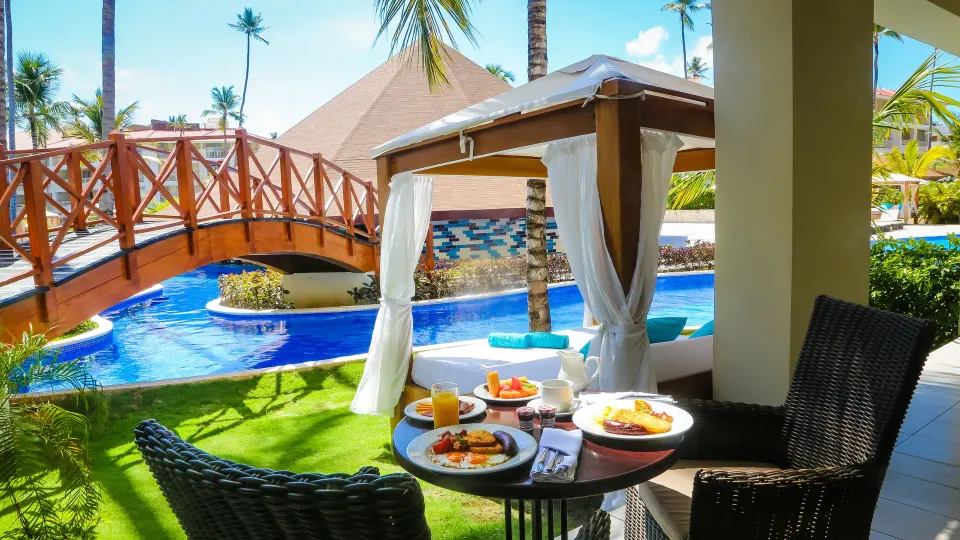 Mirage Club Swim Up Suite terrace with breakfast by the pool at Majestic Mirage Punta Cana.