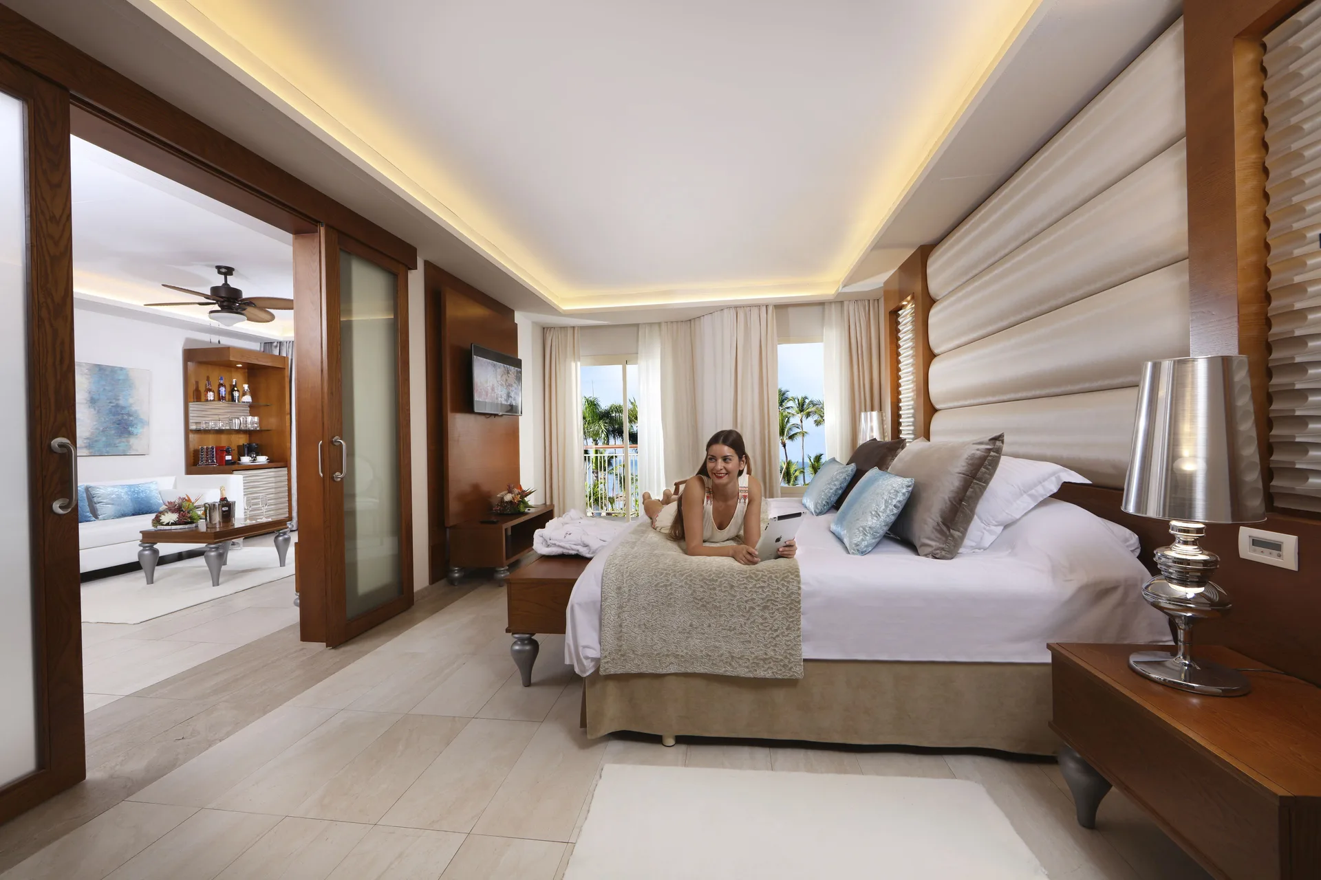 One Bedroom Suite king bed and sitting area at Majestic Mirage Punta Cana.