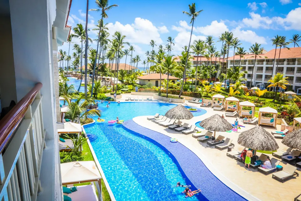 Sky View Suite balcony view over pools and palms at Majestic Mirage Punta Cana.
