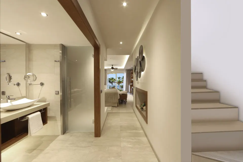 Sky View Suite bathroom, hallway, stairs, and bed at Majestic Mirage Punta Cana.