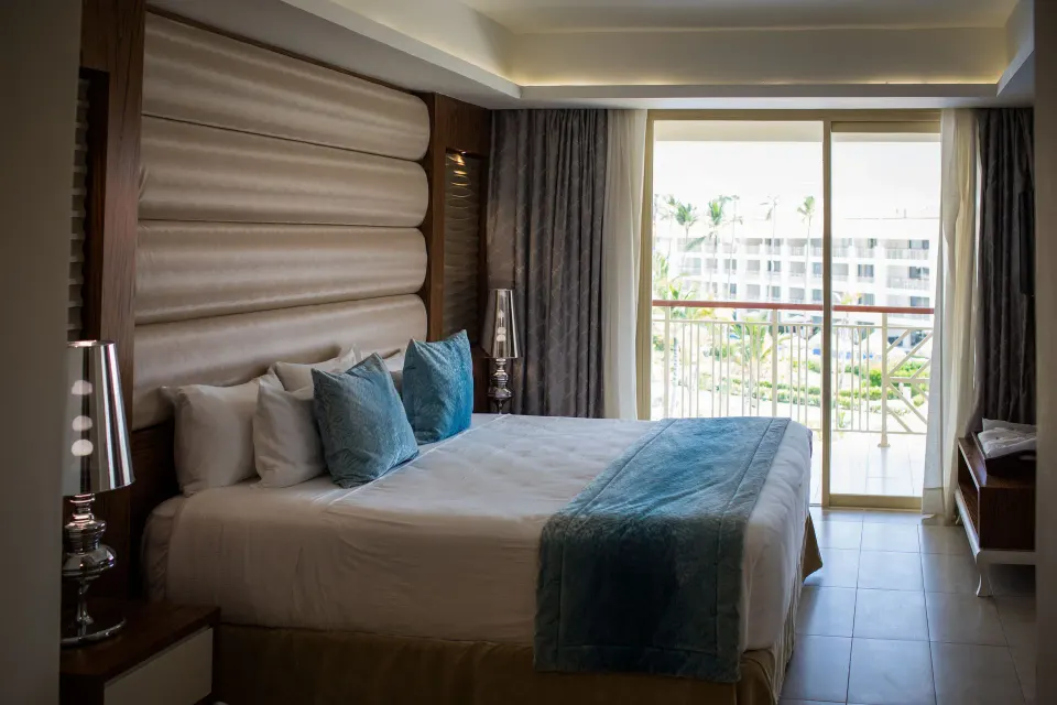 Sky View Suite king bed with balcony view at Majestic Mirage Punta Cana.