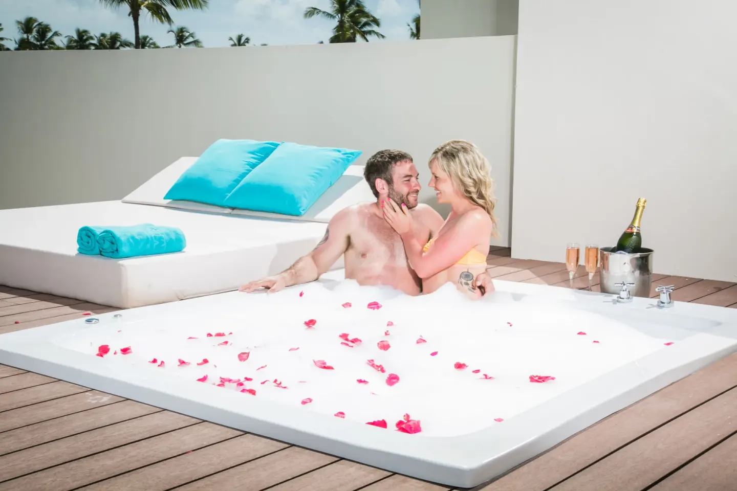 Couple in the rooftop outdoor Jacuzzi of a Sky View Suite at Majestic Mirage Punta Cana.