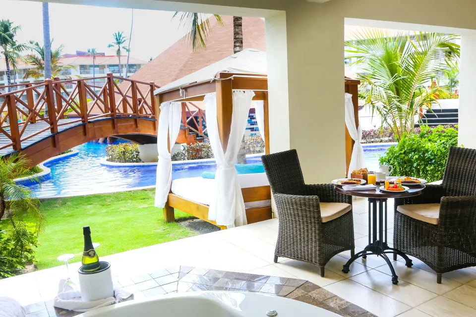 Swim Up Suite terrace with outdoor Jacuzzi, daybed and pool at Majestic Mirage Punta Cana.