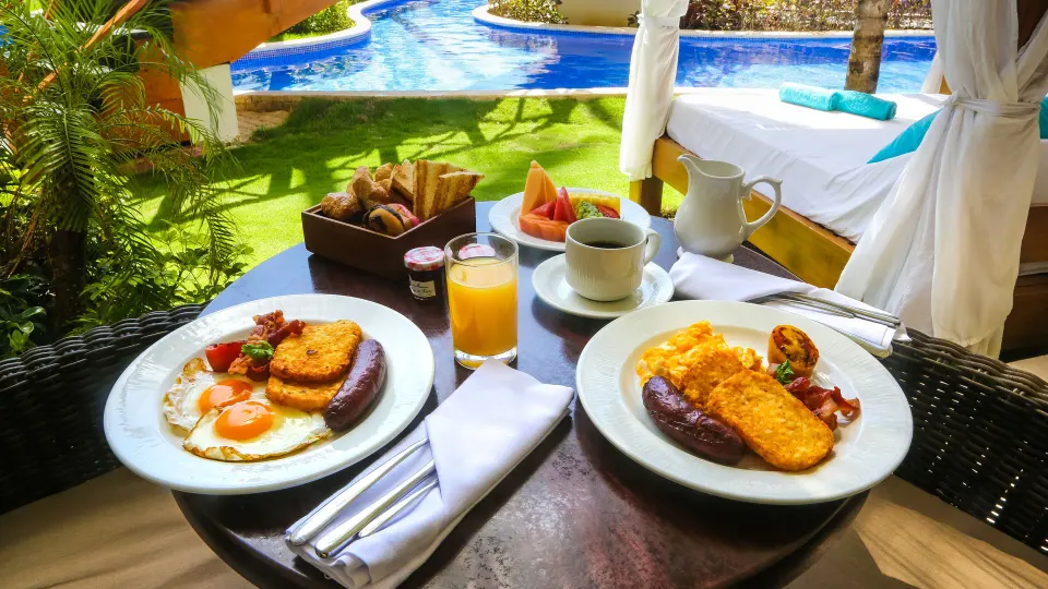 Swim Up Suite terrace breakfast beside pool and daybed at Majestic Mirage Punta Cana.
