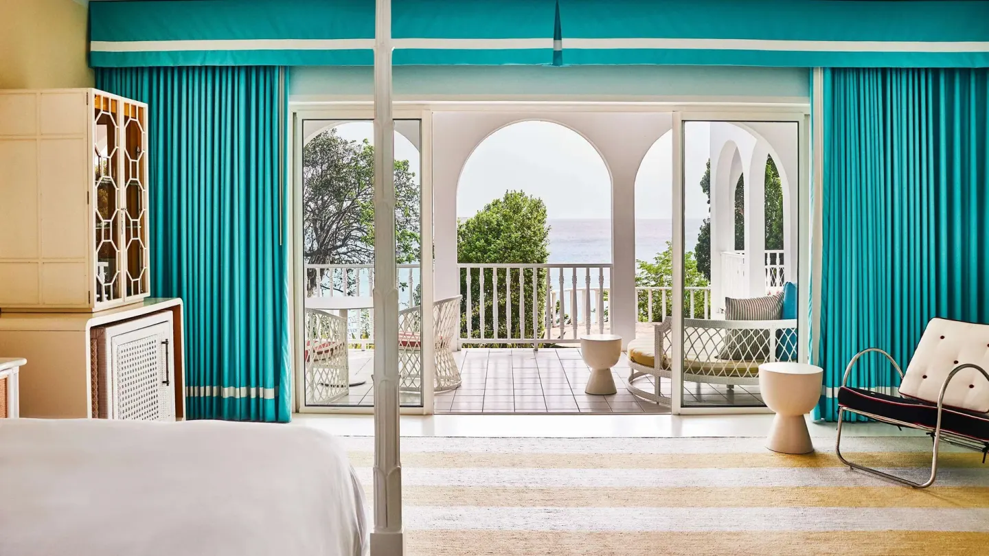 King bed room opening to an arched ocean balcony at Malliouhana Resort Anguilla.