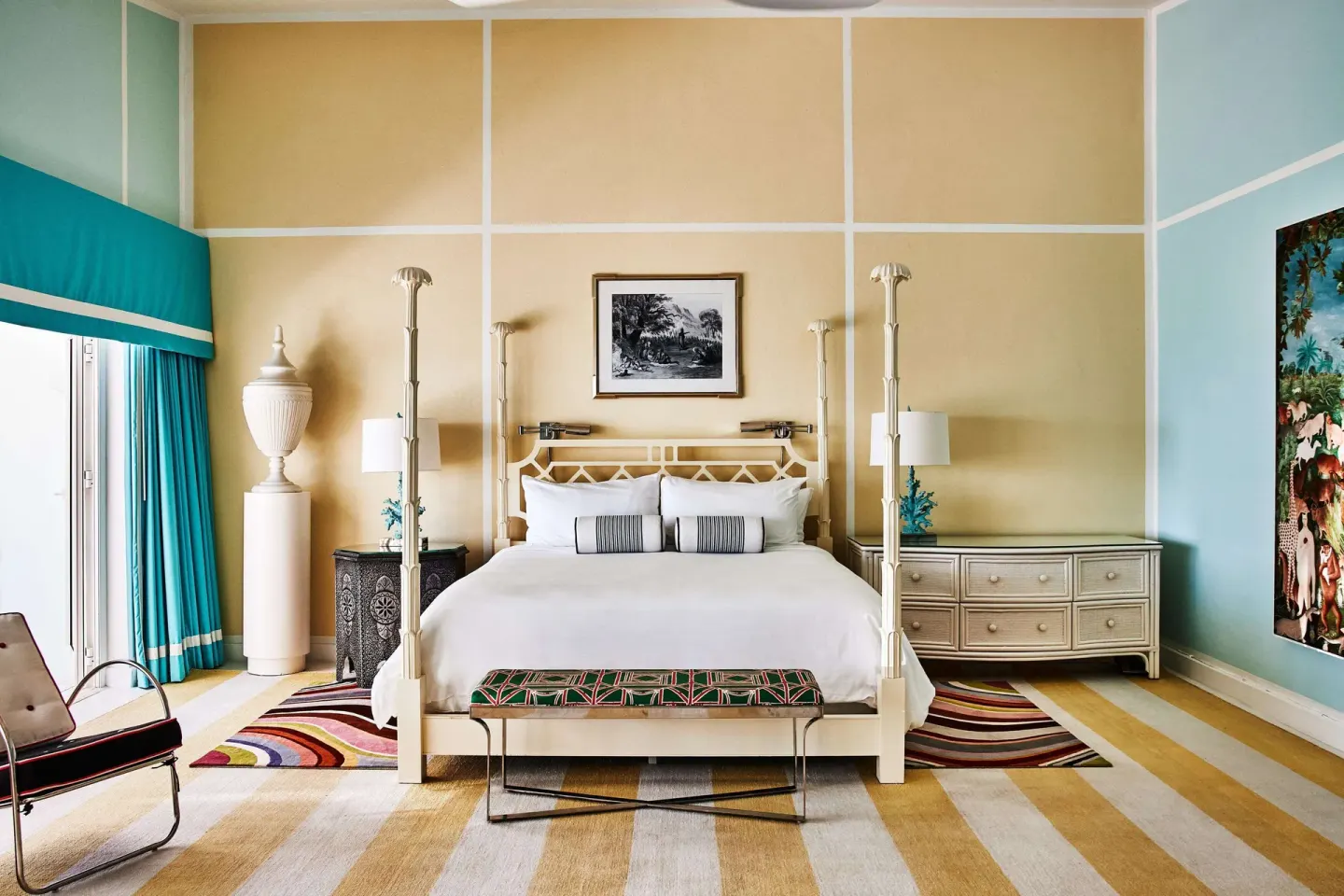 Four-poster king bed in a colorful guest room at Malliouhana Resort Anguilla.