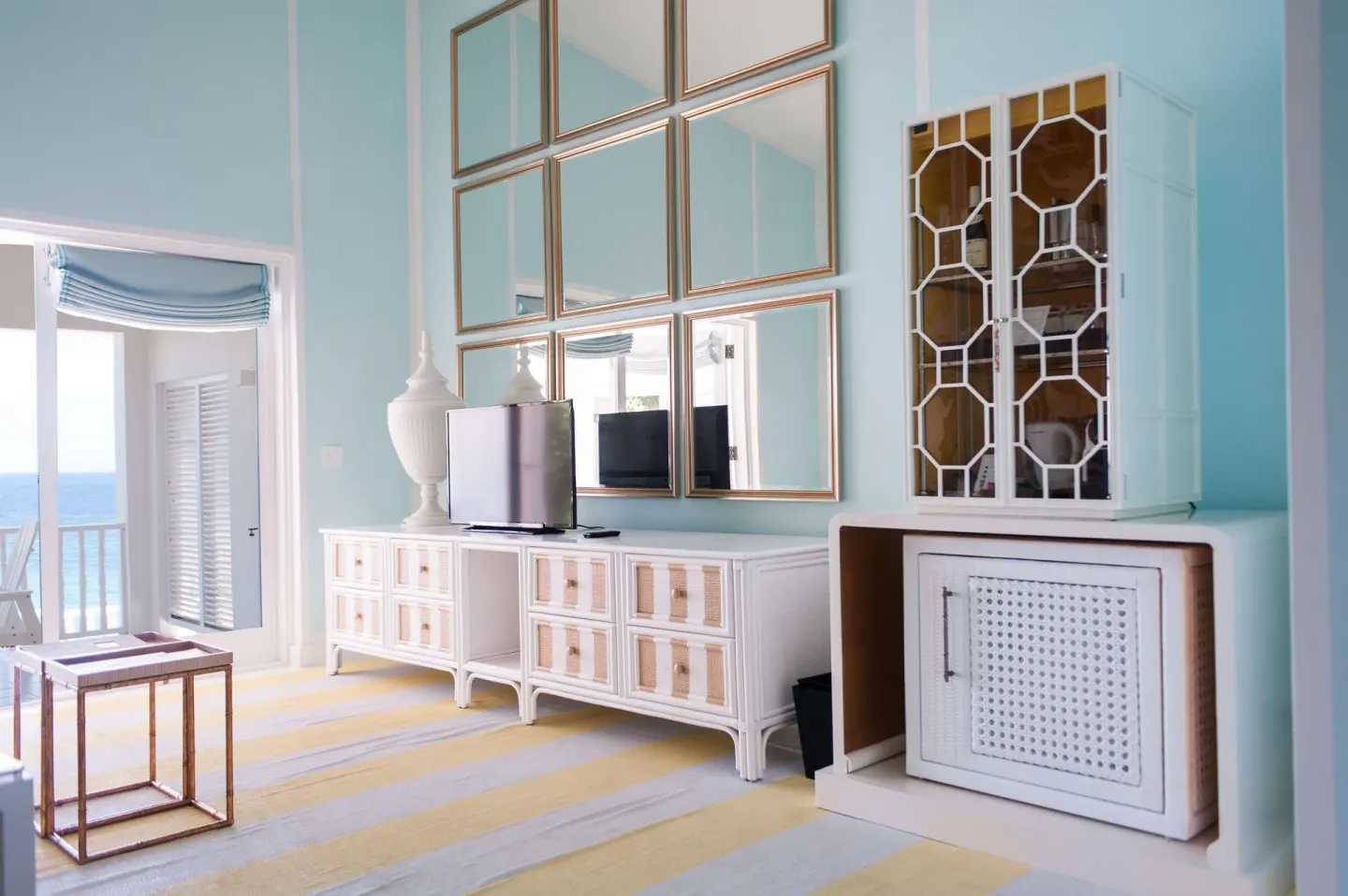 Guest suite media wall with mirrors and cabinetry at Malliouhana Resort Anguilla.