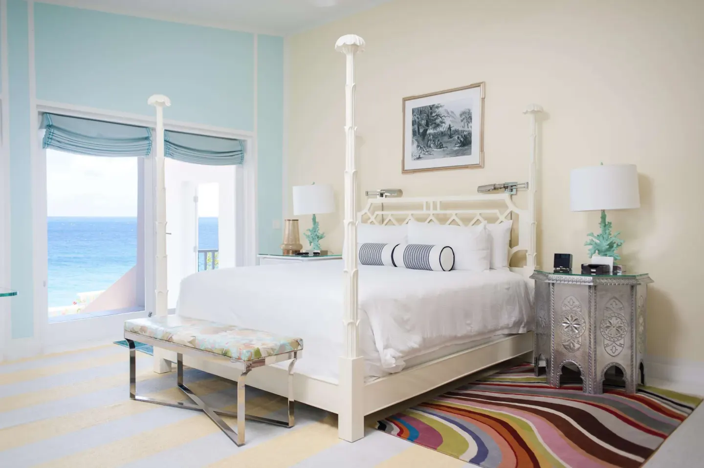 Ocean-view guest room with white four-poster bed at Malliouhana Resort Anguilla.