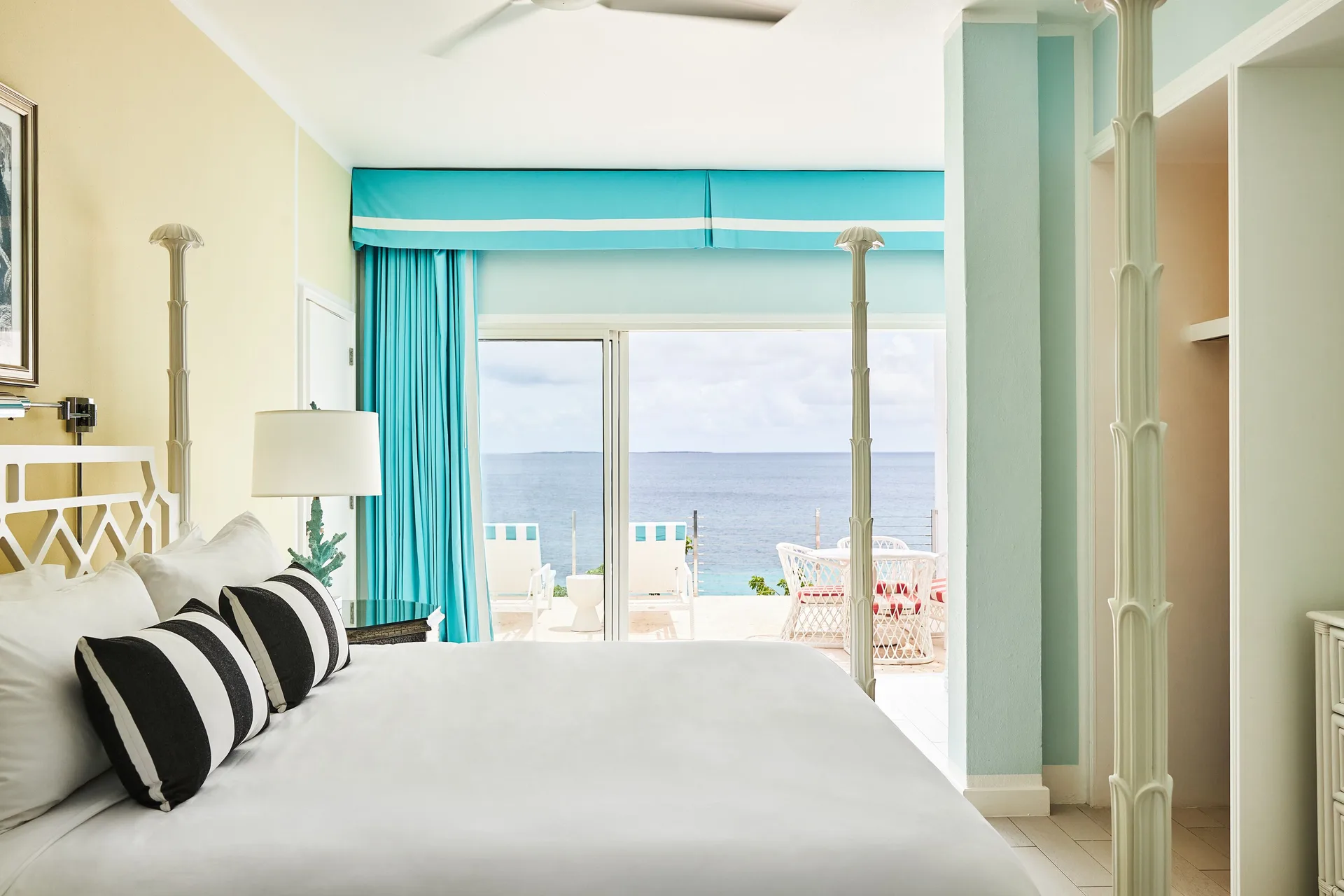 King bed guest room with ocean-facing balcony at Malliouhana Resort Anguilla.
