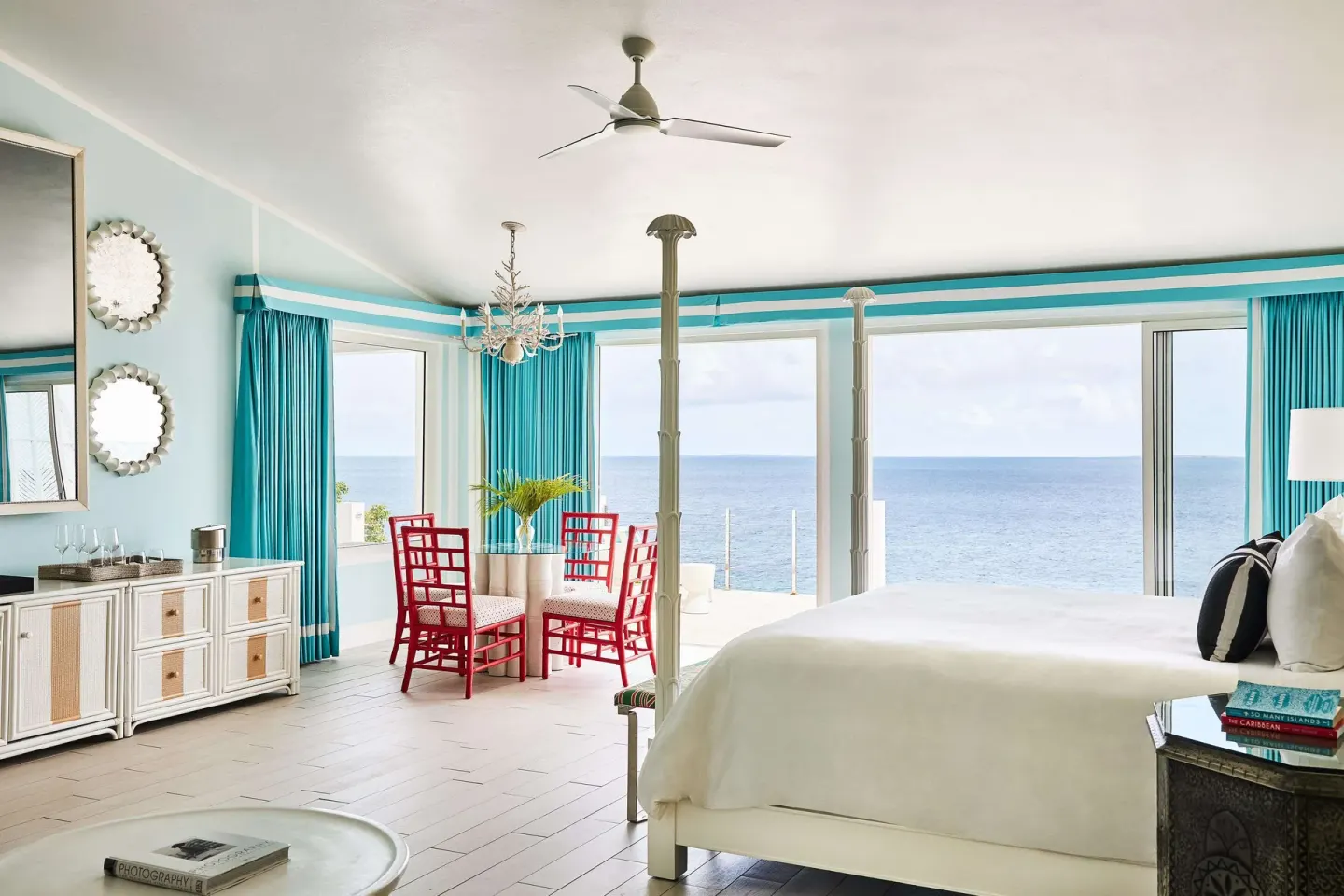 Oceanfront guest room with bed and dining table at Malliouhana Resort Anguilla.