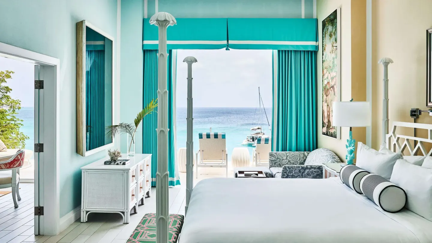 Oceanfront guest room with four-poster king bed at Malliouhana Resort Anguilla.