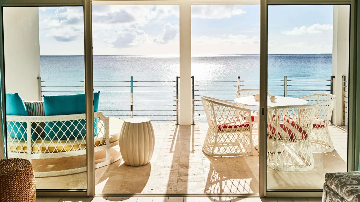 Sliding doors open to an oceanfront terrace at Malliouhana Resort Anguilla.