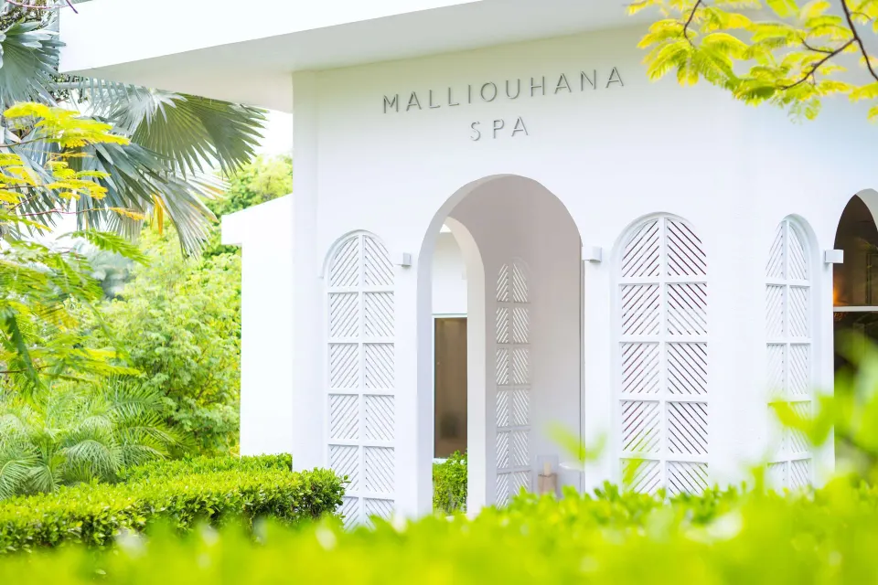 Close view of the white spa facade and arched entry at Malliouhana Resort Anguilla.
