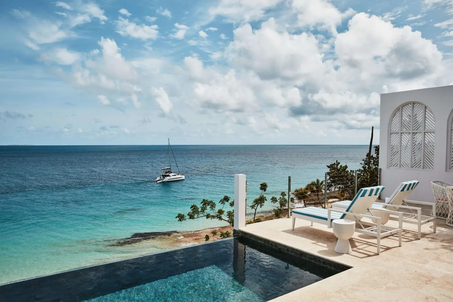 Terrace plunge pool with lounge chairs and sea view at Malliouhana Resort Anguilla.