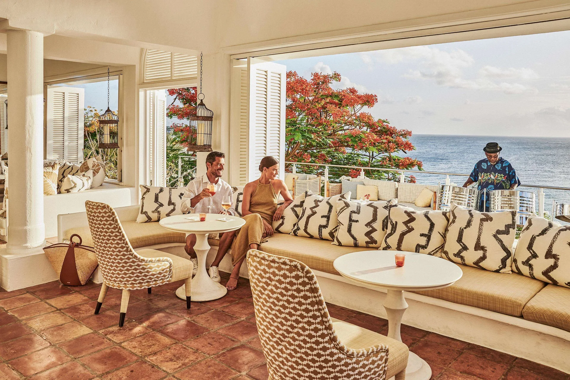 Guests relaxing in an ocean-view lounge at Malliouhana Resort Anguilla.