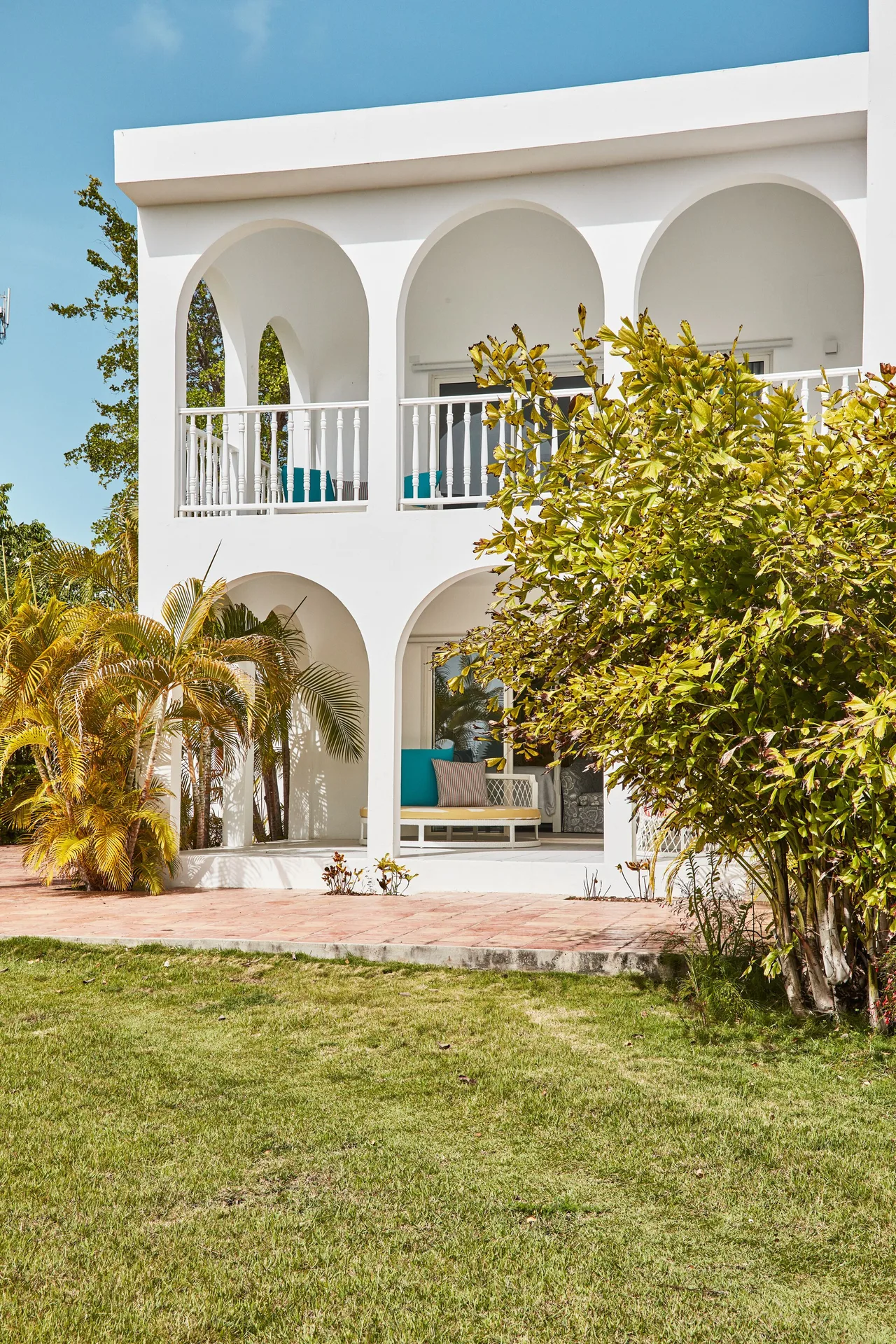 Garden View Deluxe exterior with arched balconies and lawn at Malliouhana Resort Anguilla.