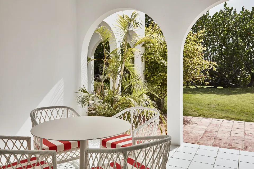 Garden View Deluxe patio dining area with arched openings at Malliouhana Resort Anguilla.