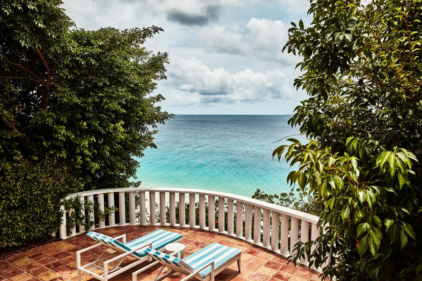 Junior Suite terrace with two loungers and ocean view at Malliouhana Resort Anguilla.