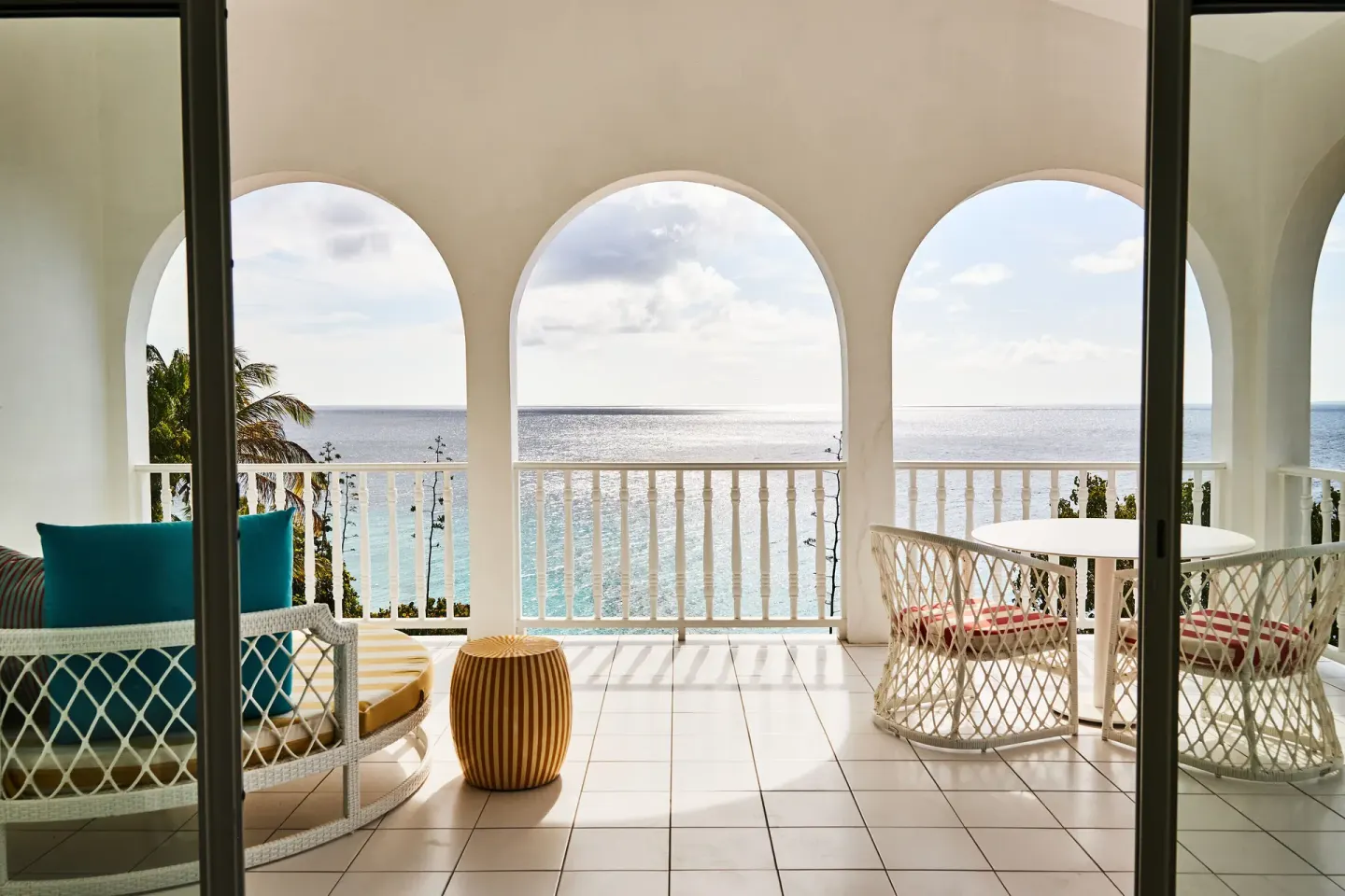 Ocean View Deluxe balcony with seating and ocean view at Malliouhana Resort Anguilla.