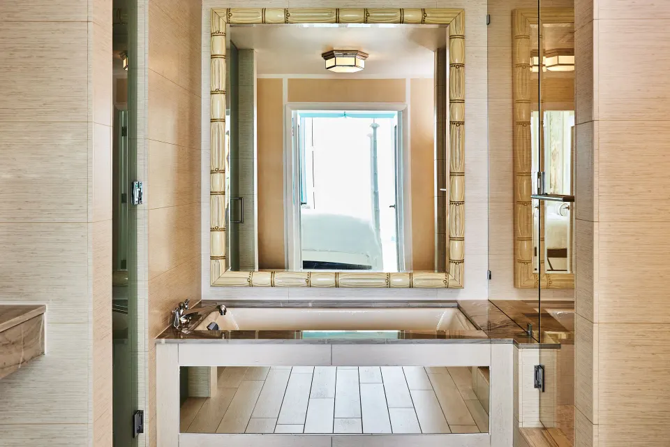 Ocean View Deluxe bathroom with soaking tub and mirrors at Malliouhana Resort Anguilla.