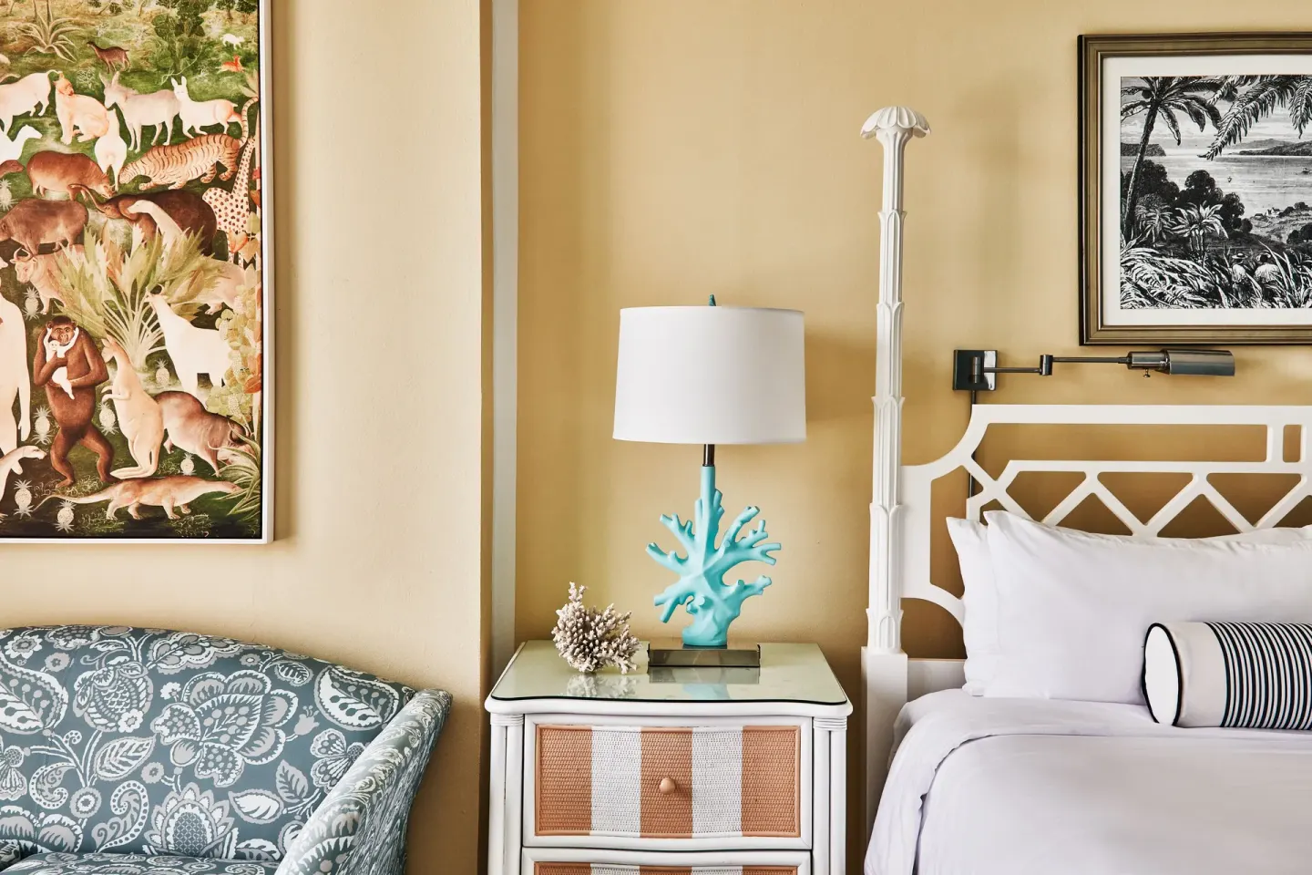 Ocean View Deluxe room bed, nightstand and patterned chair at Malliouhana Resort Anguilla.