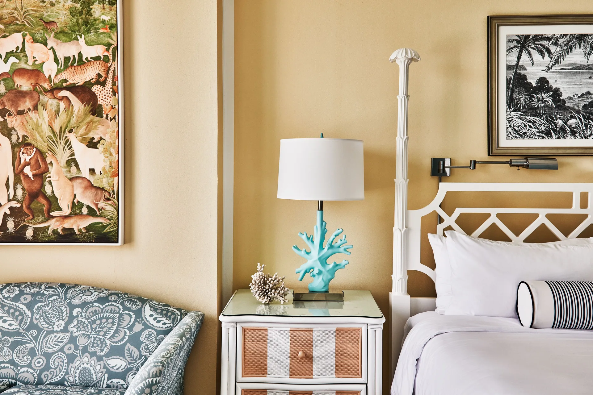 Ocean View Deluxe room bed, nightstand and patterned chair at Malliouhana Resort Anguilla.