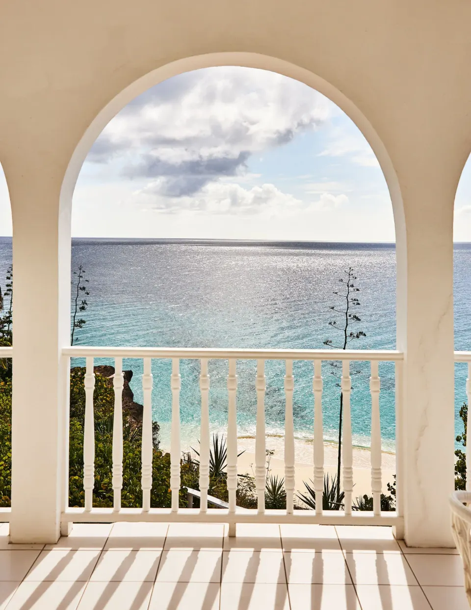 Ocean view from the Ocean View Premium Two Beds terrace at Malliouhana Resort Anguilla framed by arches.
