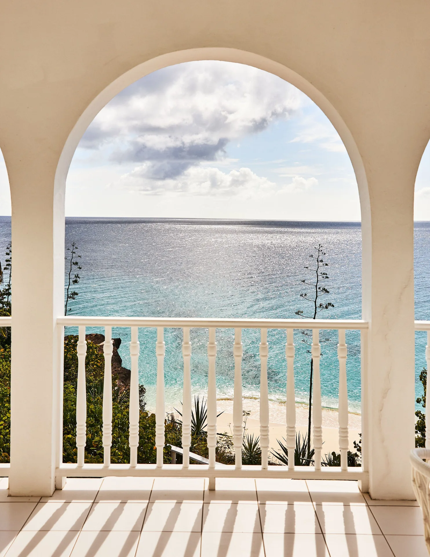 Ocean view from the Ocean View Premium Two Beds terrace at Malliouhana Resort Anguilla framed by arches.