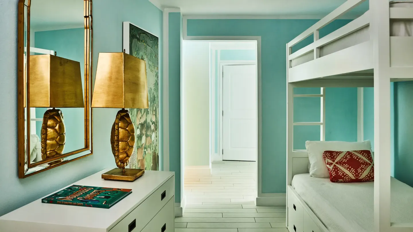 Spa Suite bunk alcove with turquoise walls and dresser at Malliouhana Resort Anguilla.