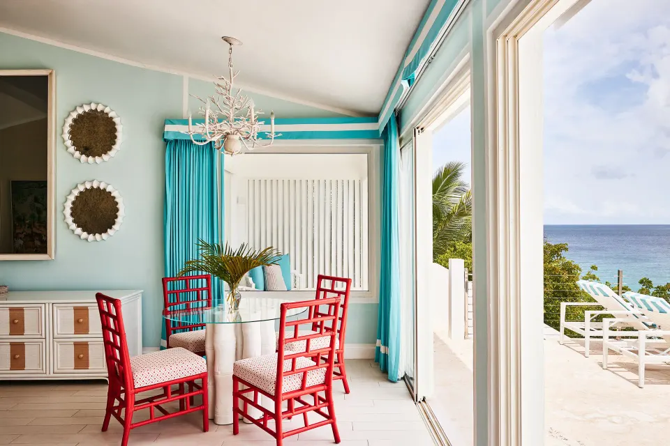 Turtle Cove Suite dining nook beside ocean-view doors at Malliouhana Resort Anguilla.