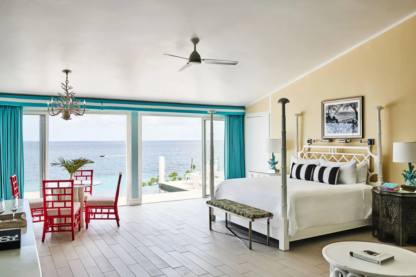 Turtle Cove Suite king bed and dining area facing the sea at Malliouhana Resort Anguilla.
