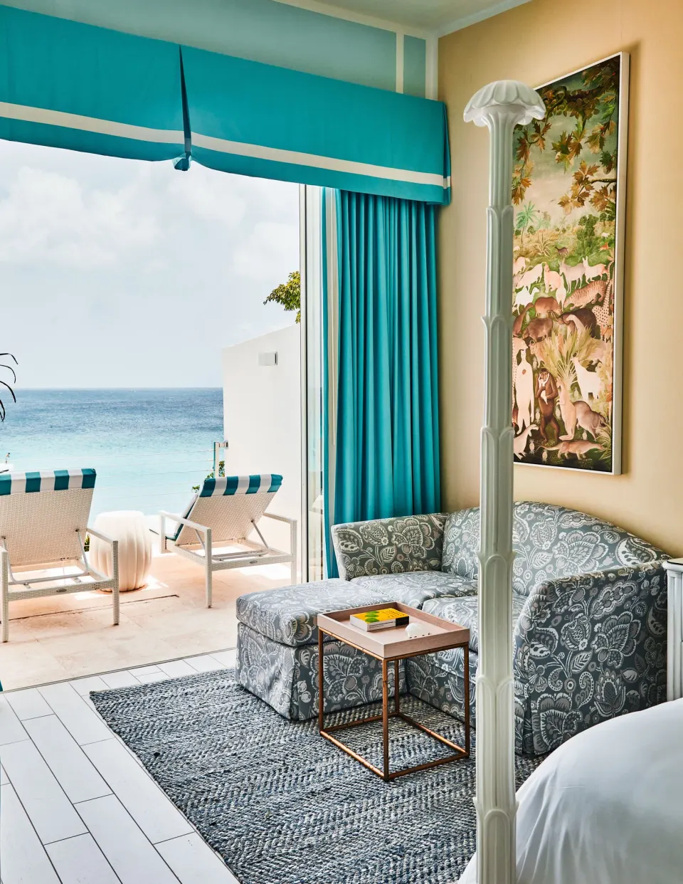 Turtle Cove Suite lounge chair area opening to ocean terrace at Malliouhana Resort Anguilla.