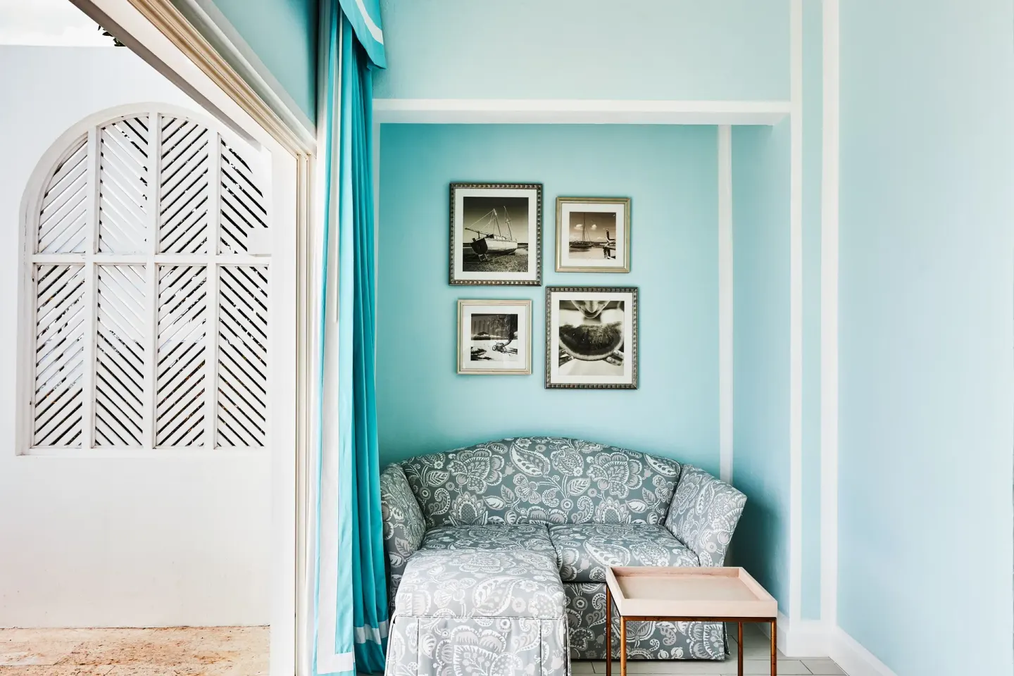 Turtle Cove Suite blue sitting alcove with patterned sofa at Malliouhana Resort Anguilla.