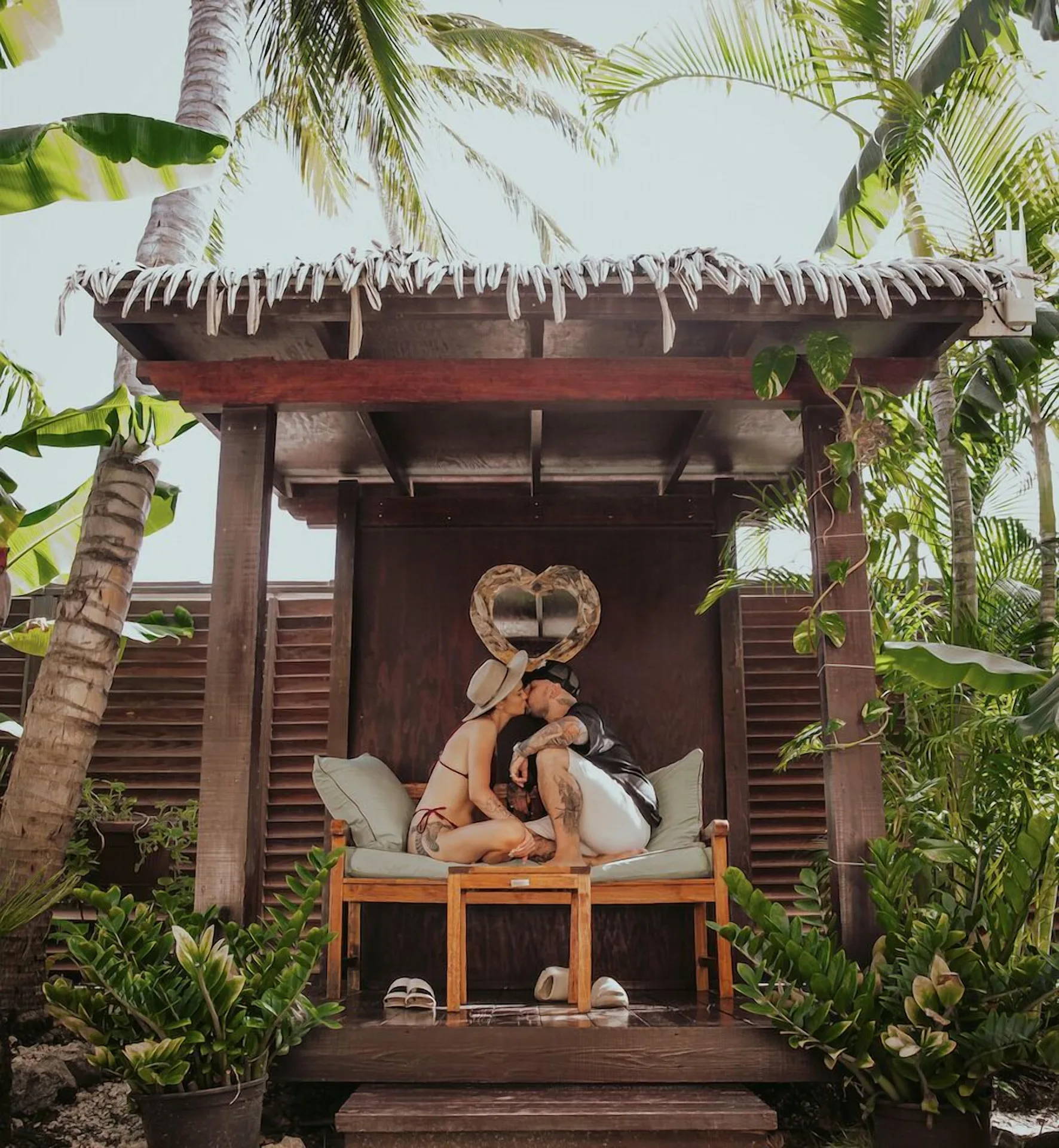Couple seated in a garden cabana at Manchebo Beach Resort and Spa.