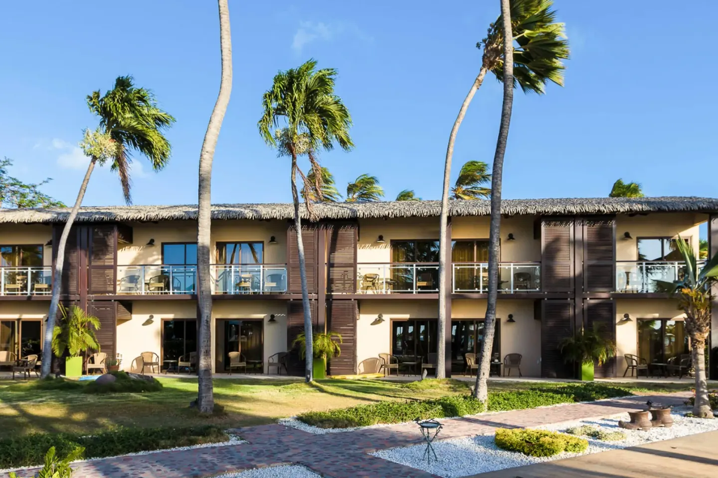 Two-story guest room building with balconies at Manchebo Beach Resort and Spa.