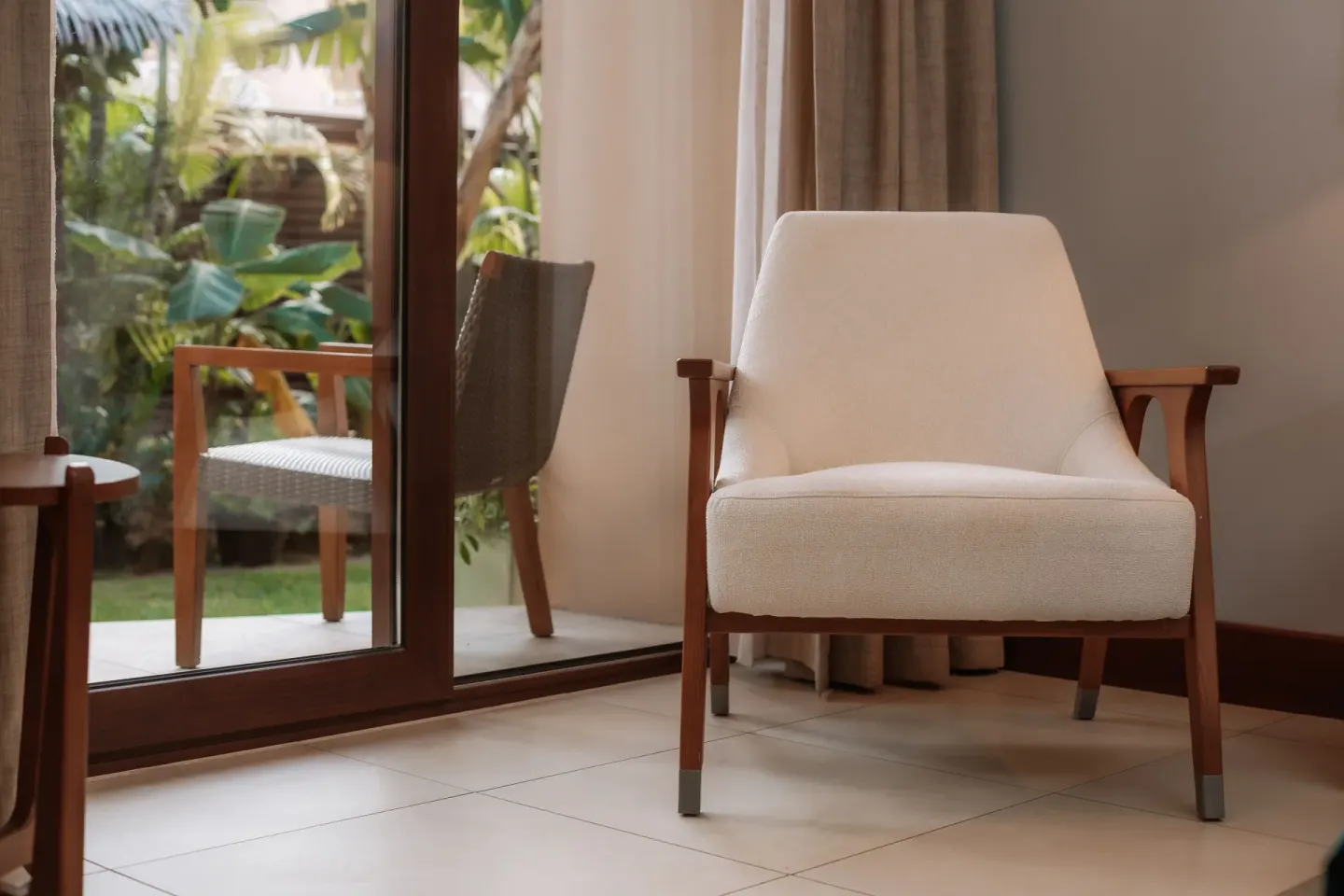 Indoor lounge chair beside sliding patio doors at Manchebo Beach Resort and Spa.