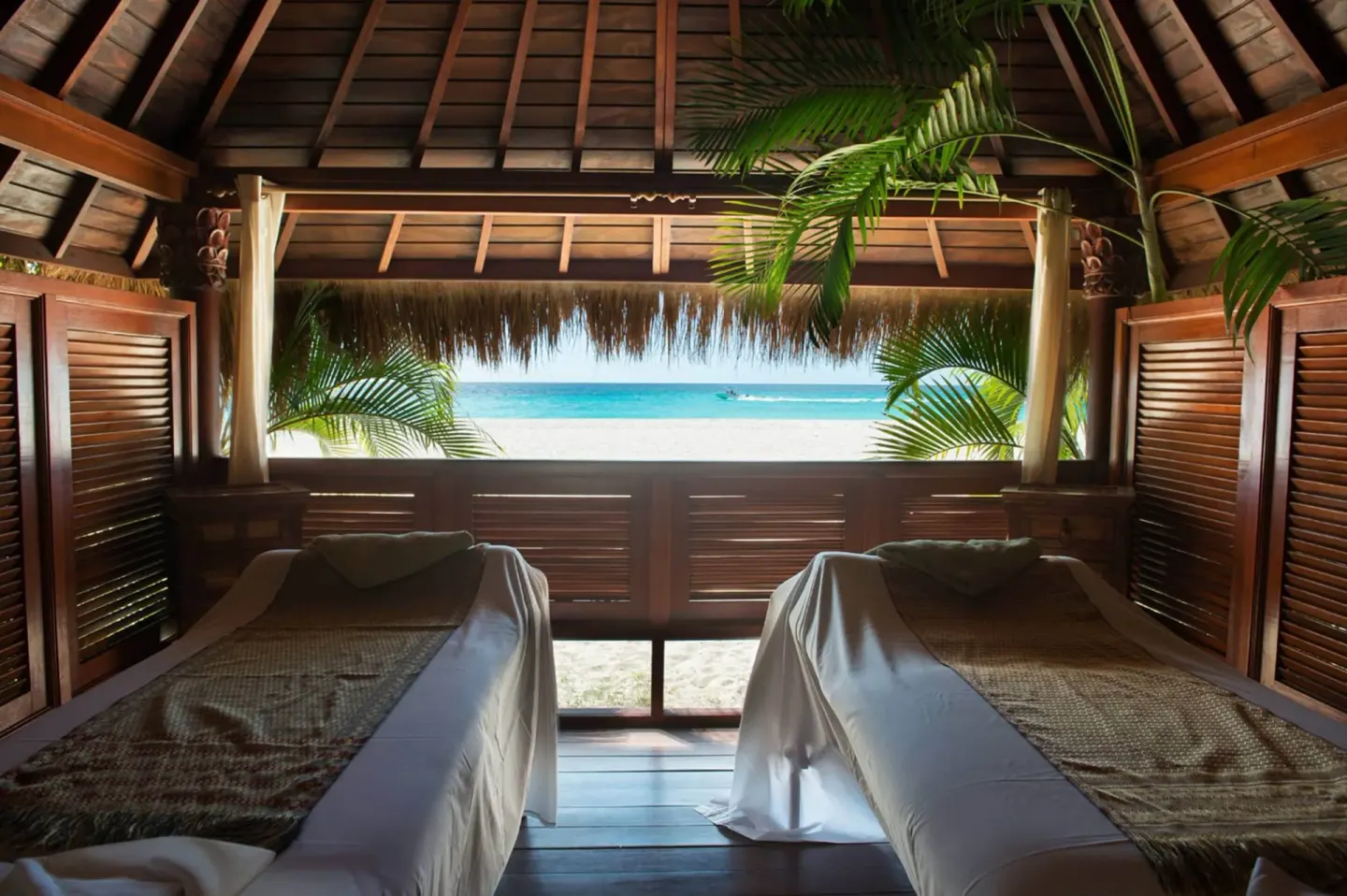 Twin spa treatment beds facing the ocean at Manchebo Beach Resort and Spa.