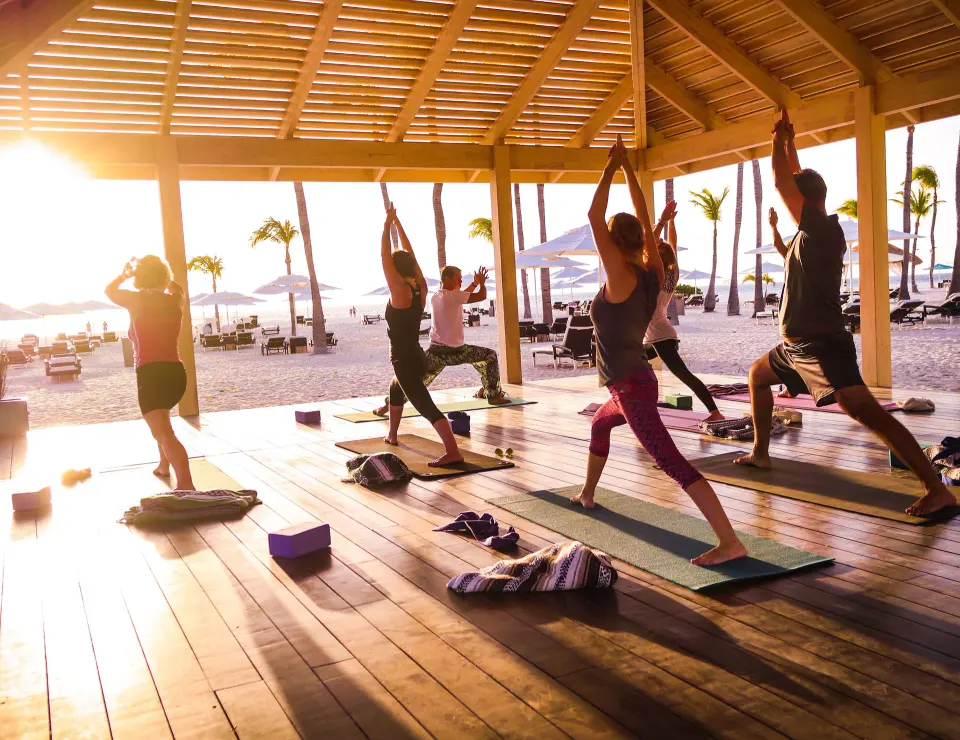 Sunset yoga class in a beachfront pavilion at Manchebo Beach Resort and Spa.