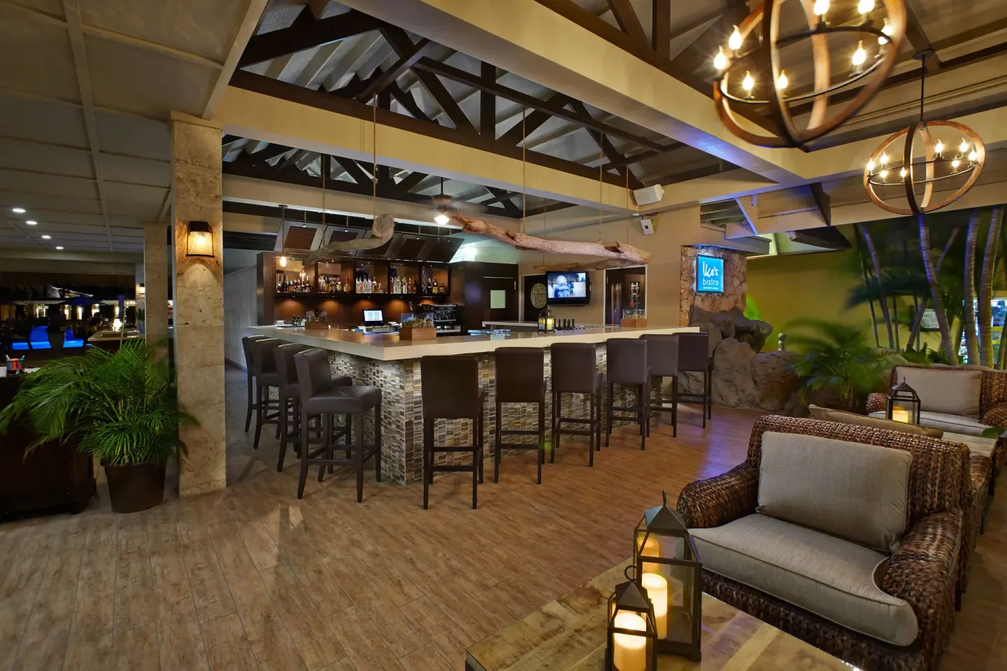 Open-air bar lounge with wicker seating at Manchebo Beach Resort and Spa.