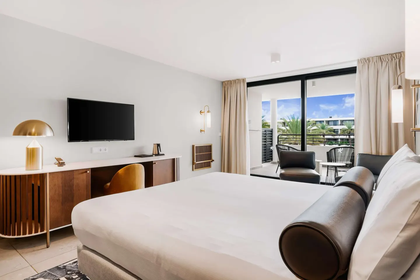 King guest room with balcony seating at Mangrove Beach Corendon Curacao Resort.