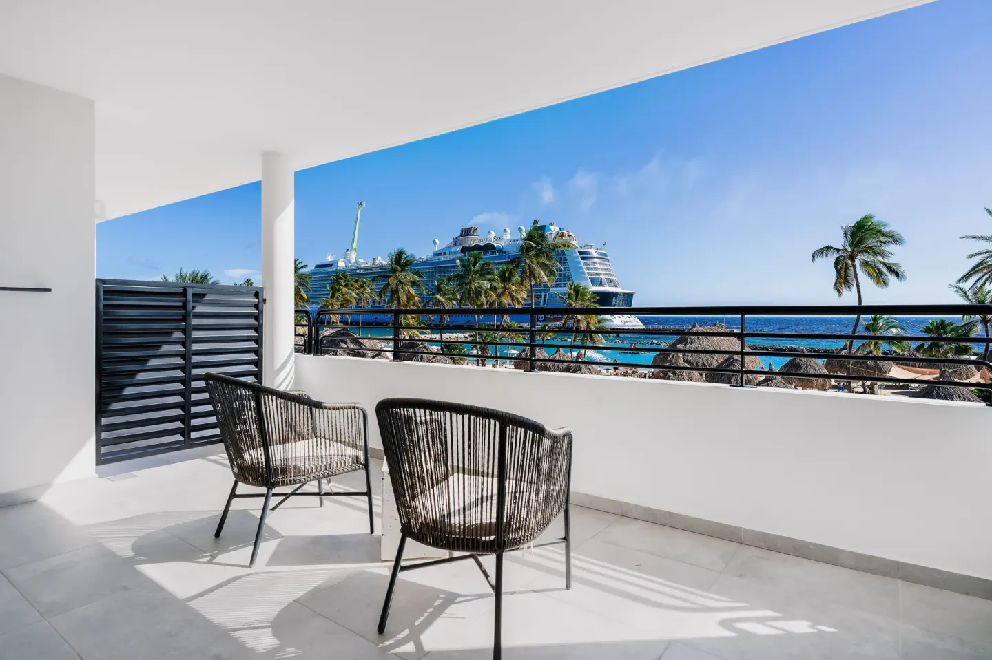 Balcony seating with ocean and cruise ship views at Mangrove Beach Corendon Curacao Resort.