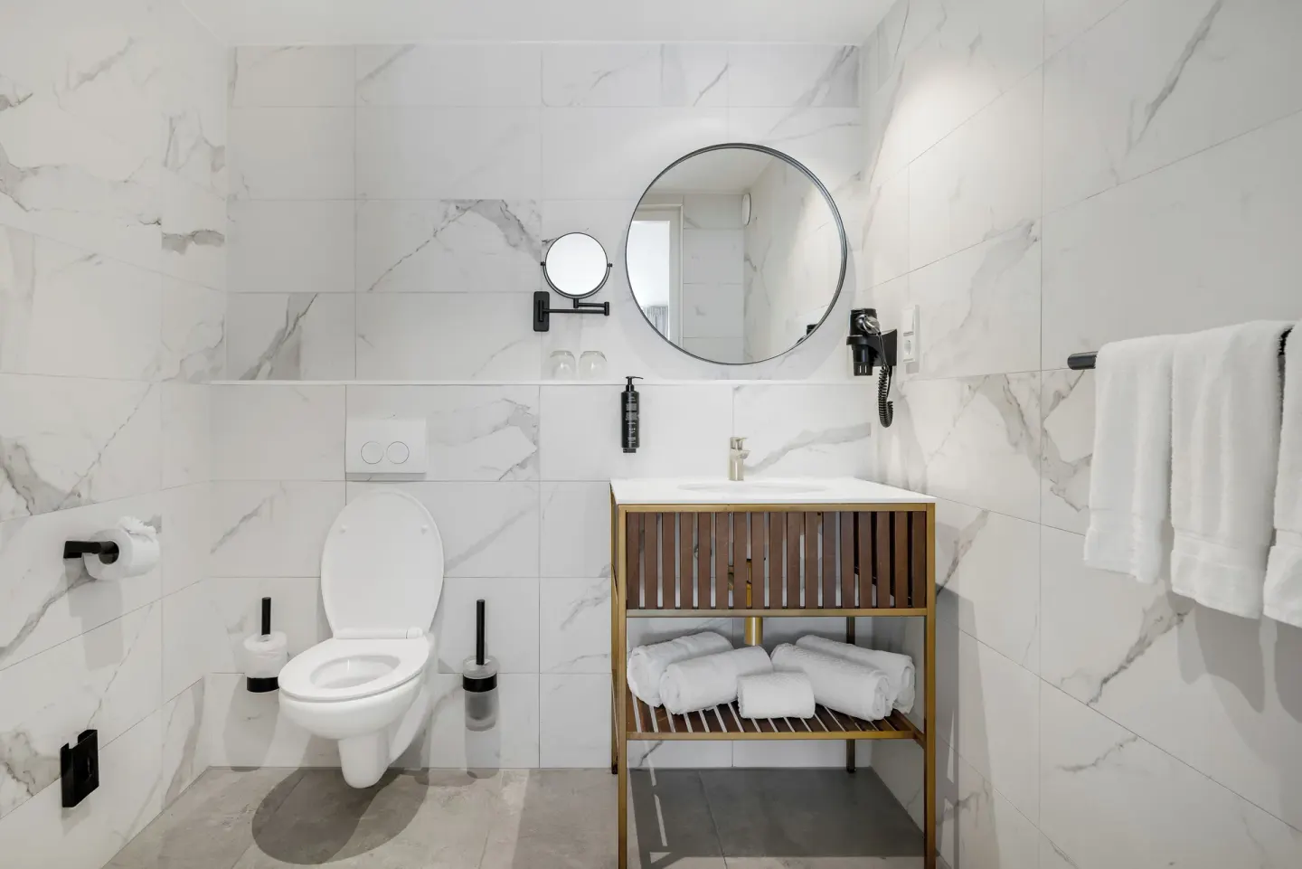 Bathroom with toilet, vanity and towel rail at Mangrove Beach Corendon Curacao Resort.