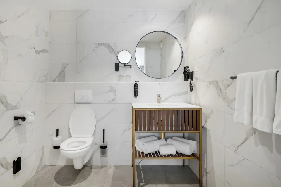 Bathroom with toilet, vanity and towel rail at Mangrove Beach Corendon Curacao Resort.
