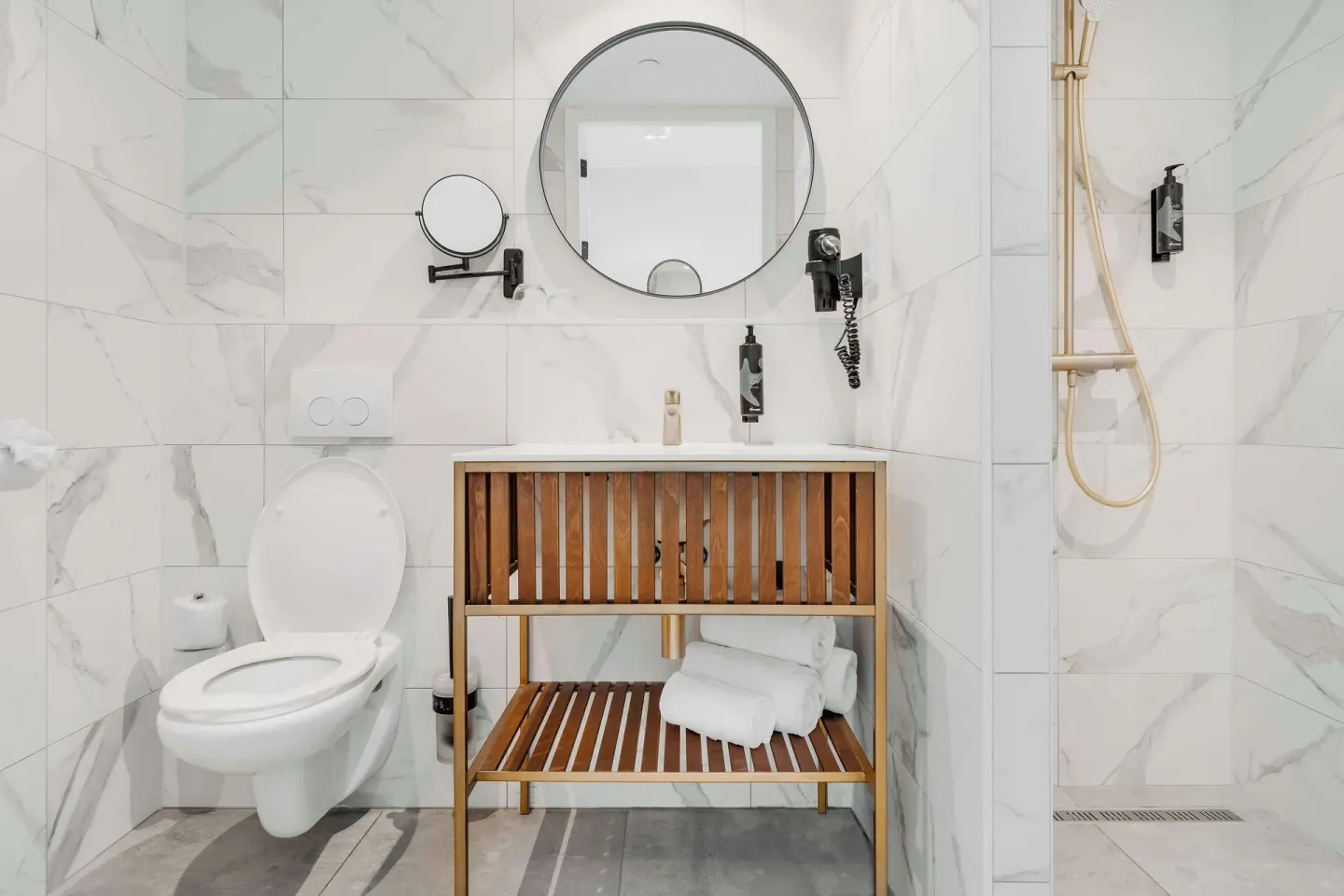 Guest bathroom with vanity, toilet, and walk-in shower at Mangrove Beach Corendon Curacao Resort.
