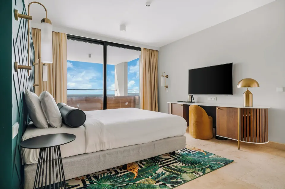 King bed guest room with balcony at Mangrove Beach Corendon Curacao Resort.