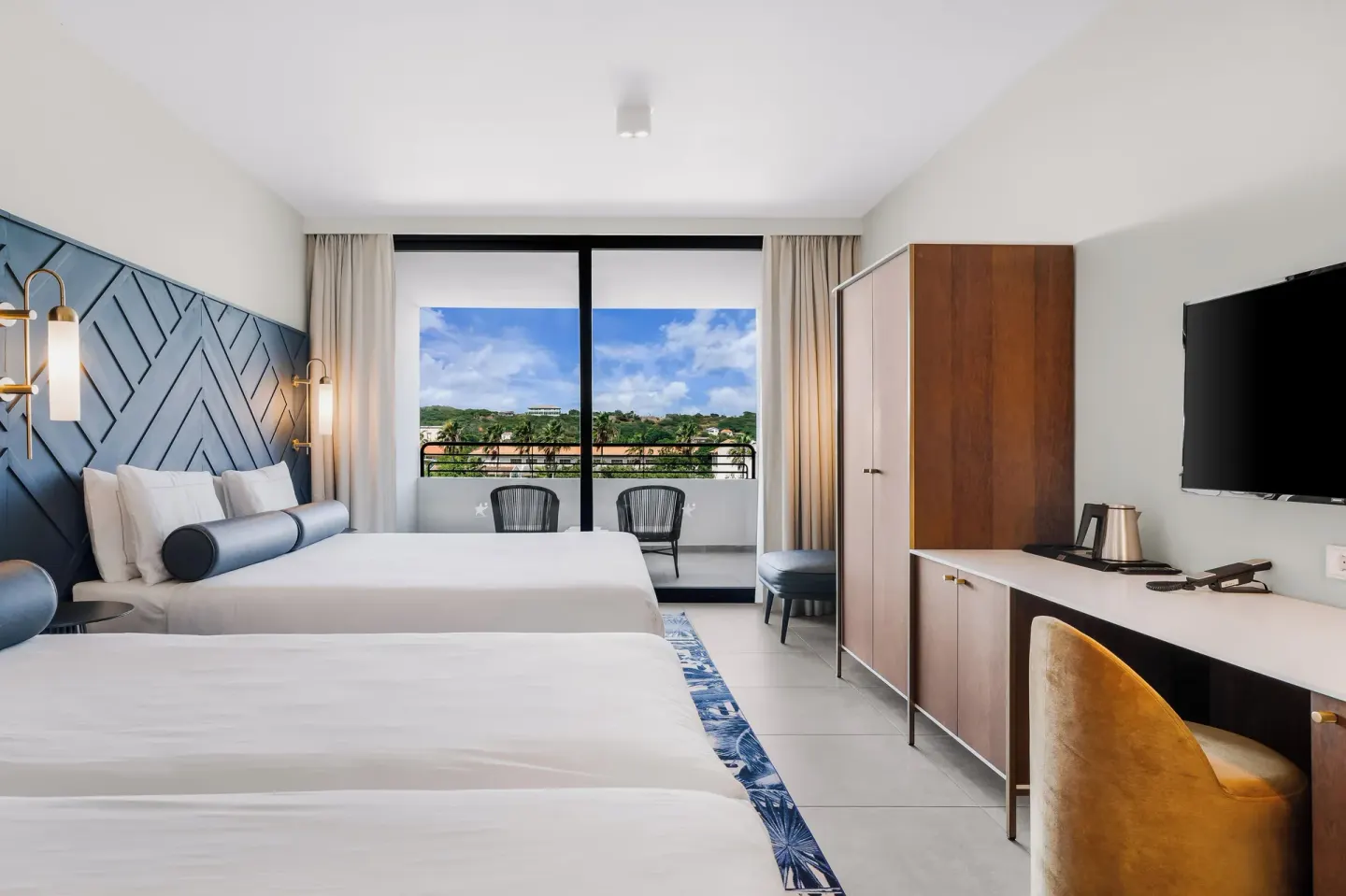Two-bed guest room looking toward the balcony at Mangrove Beach Corendon Curacao Resort.
