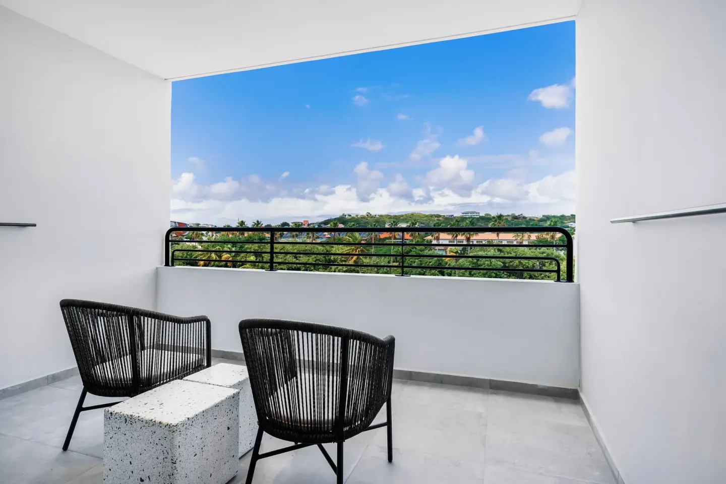 Balcony seating with inland hillside view at Mangrove Beach Corendon Curacao Resort.