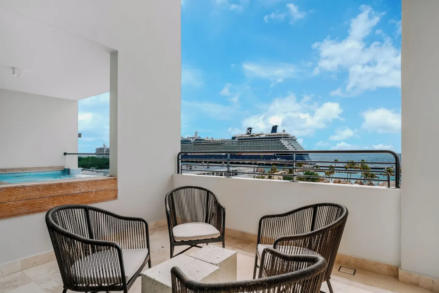 Large balcony with chairs and ocean view at Mangrove Beach Corendon Curacao Resort.